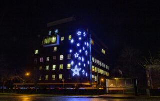 The from of Lincoln County Hospital's maternity wing decorated with bright white light up stars.