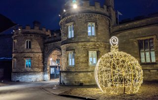 Gold light up bauble motif displayed outside the entrance to Lincoln Castle.